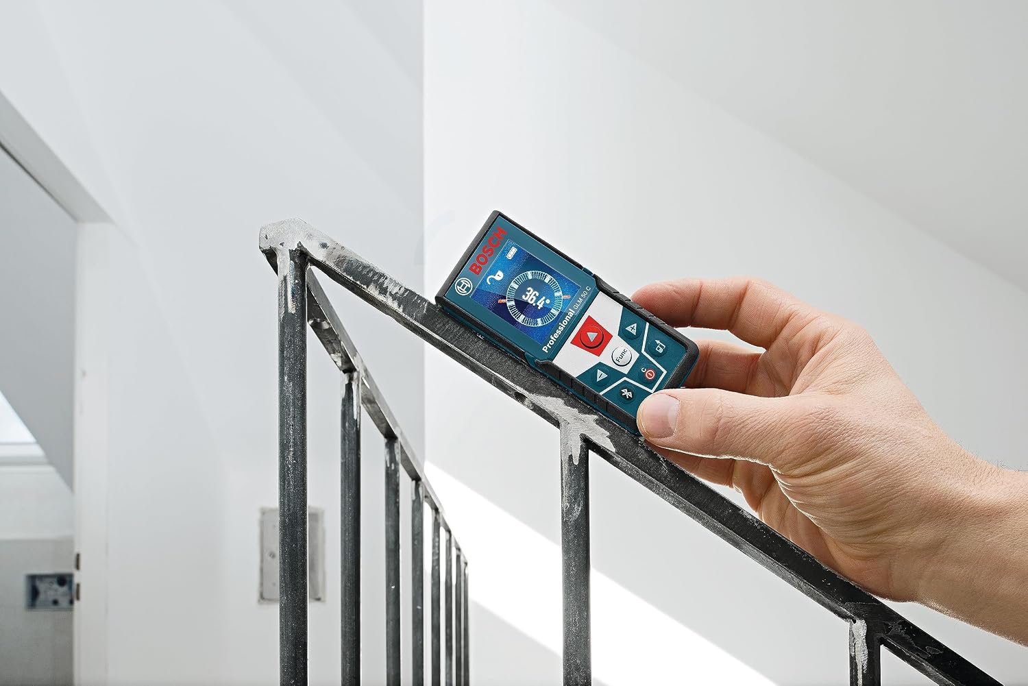Winner pick: Bosch GLM50C measuring a stair rail angle with the built-in inclinometer